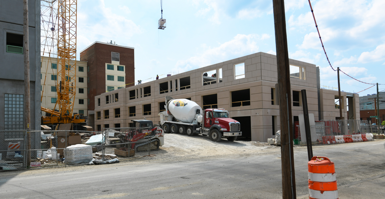 A precast concrete building under construction with a crane.