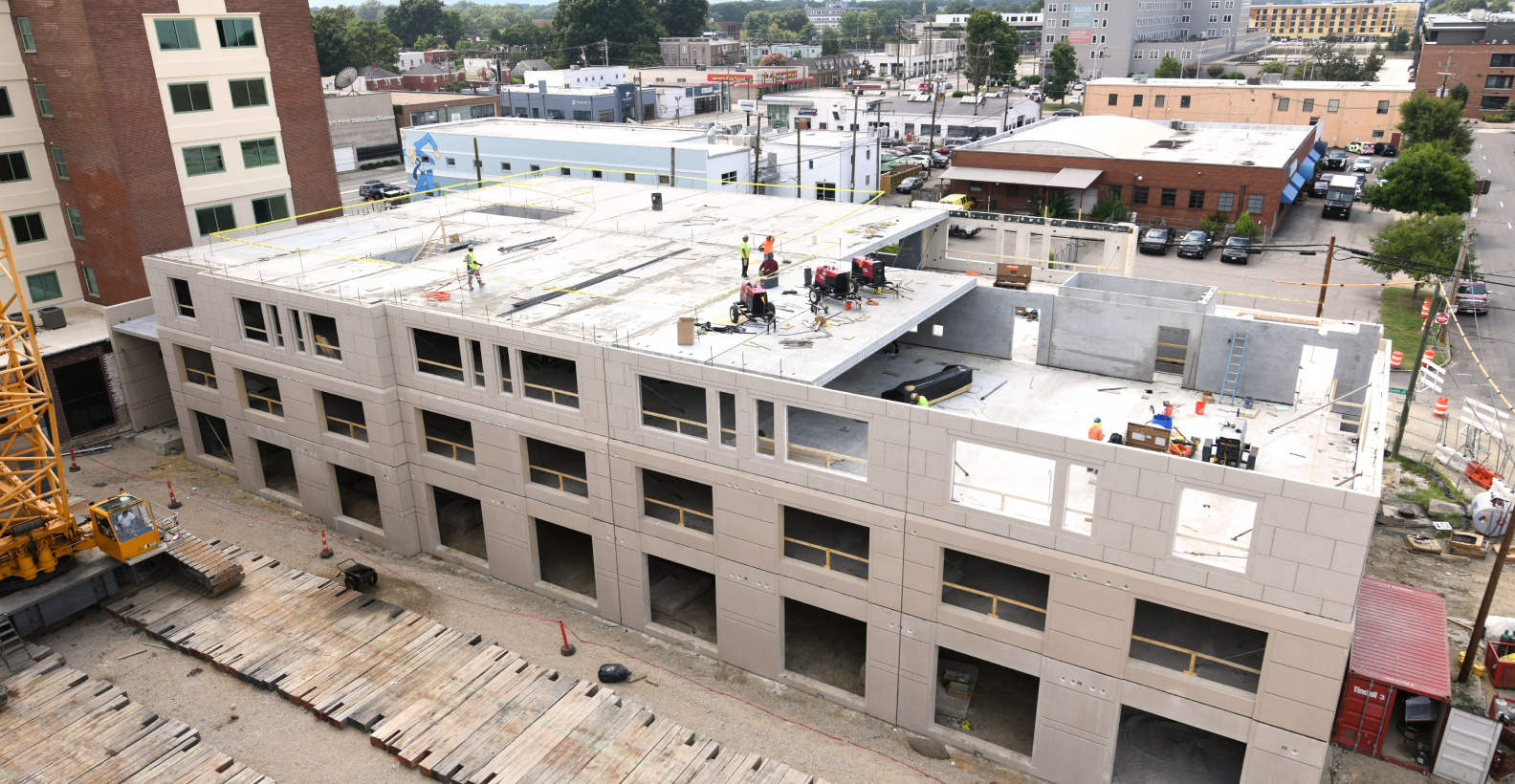 An overhead view of a precast concrete, commercial building undergoing construction
