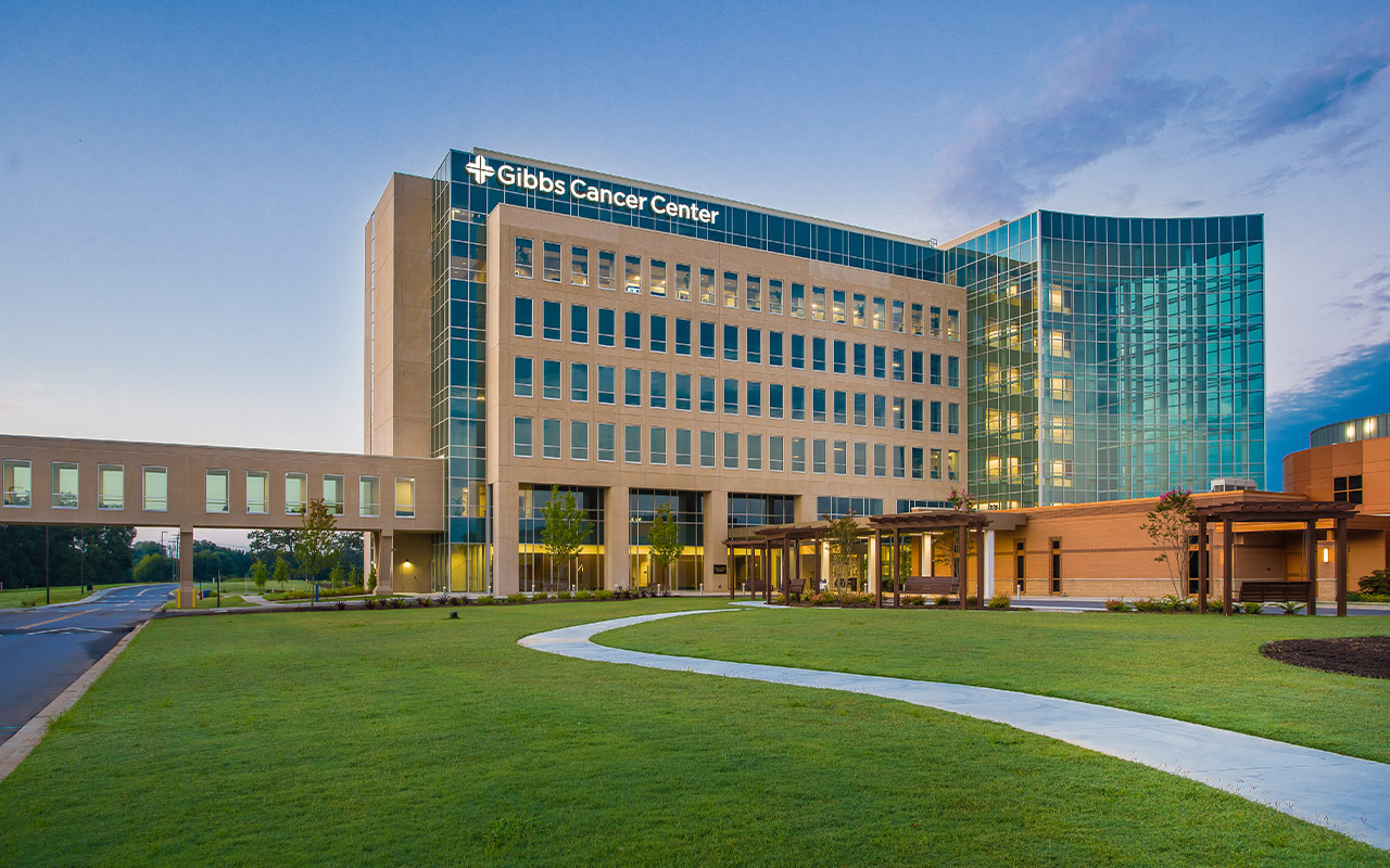 a landscape view of the Gibbs Cancer Center building and pedestrian bridge customized by Tindall Corporation